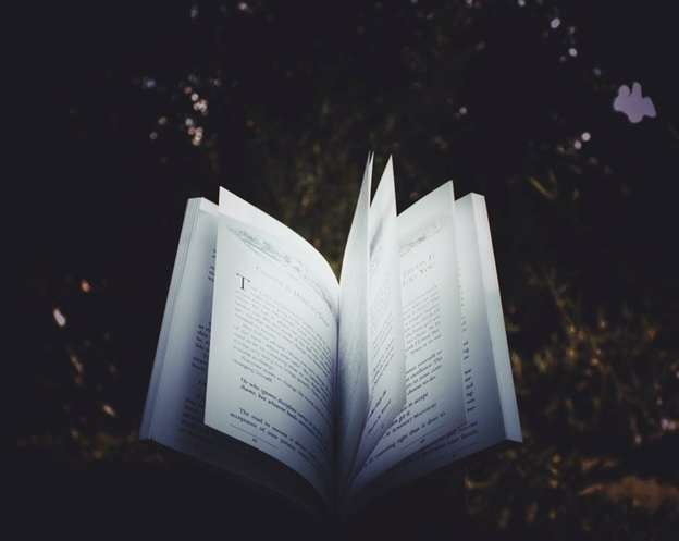 An opened book against a dark background